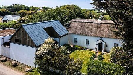 Two homes for the price of one: Thatched cottage and bungalow on sale together