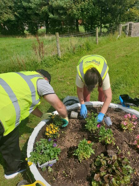 Sean and Mags, Elphin Tidy Towns team hard at week on planters on Mart Road.