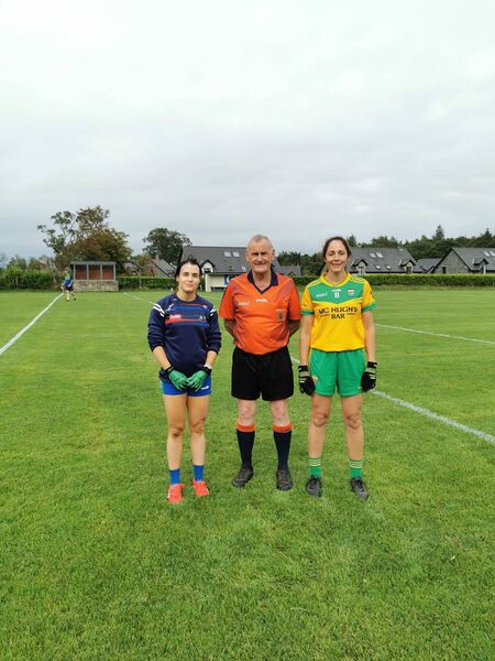 Captains Danielle Gannon (St. Michael's/St. Ronan's) and Aisling O'Hart (Shannon Gaels) with referee Vivian Hardiman before their junior championship game in Croghan on Friday evening.