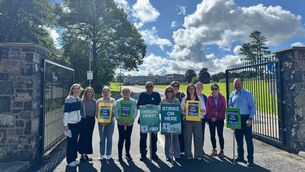 <p>Colaiste Chiarain Principal Brendan Waldron pictured on the right and other staff members visit the picket line outside the school to show their support.</p>