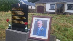 <p>A photograph of the late Liam Farrell beside a memorial plaque at his Roosky home.</p>