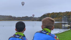 <p>Two young boys enchanted by the scene of departing hot air balloons at Lough Key Forest Park, Boyle. Pic: Gerard O'Loughlin </p>