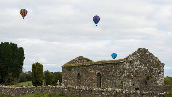 Hot air balloons pass by Eastersnow old church. Pic: Gerry Faughnan