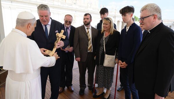 The handcrafted crucifix presented to Pope Leo by the Mullooly family was made by Willie Creighton, who delivers wood turning classes at Men's Shed in County Roscommon. L-R: Pope Leo; MEP Ciaran Mullooly, Ciaran's brother Donal; Donal's son, Matthew who flew in from New York; Ciaran's son Bryan; Ciaran's wife Angela and their other son Eoghan, and Fr Turlough Baxter, PP Lanesborough.
