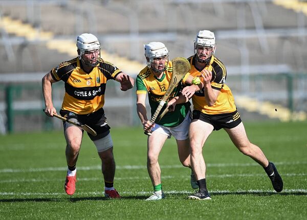 Paddy Fallon is the meat in the sandwich as Four Roads duo, Eamon Mulry and Tommy Morris, tackle the Oran forward during Sunday's county senior hurling semi-final at King and Moffatt Dr. Hyde Park. 