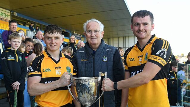 <p>Four Roads joint captains, Conor Coyle and Jack Donnelly, accept the Mickey Cunniffe Cup from Roscommon Hurling Chairperson, Christy McDermott, following their side's victory against Oran at King and Moffatt Dr. Hyde Park on Sunday last. Pictures: Gerard O'Loughlin</p>