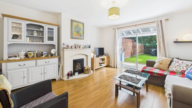 <p>The sitting room features an inviting open fire and French doors allow natural light to flood the room and open onto a private back garden.</p>