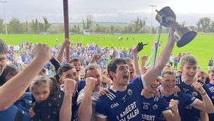 <p>St. Croan's captain Ger Connaughton lifts the cup to confirm his team as Junior A football champions following their victory against Ballinameen in Saturday's final at Strokestown. Picture: Brian Carroll</p>