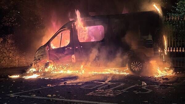 Fireworks launched at gardaí, Garda van set alight, in clash with protesters at Citywest