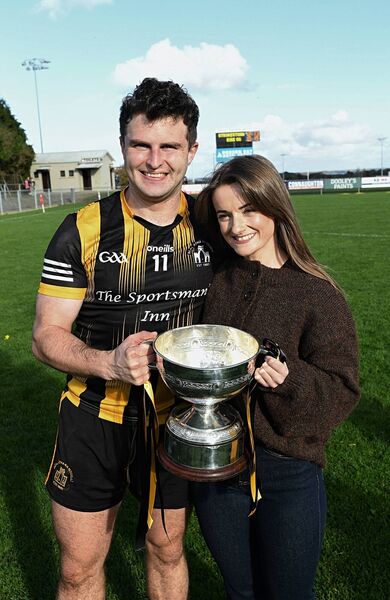 Strokestown centre-forward Kevin Finn with Laura Fitzgerald and the Jamesie Murray Cup following their side's intermediate football championship triumph against Éire Óg on Sunday last. Picture: Gerard O'Loughlin Strokestown centre-forward Kevin Finn with Laura Fitzgerald and the Jamesie Murray Cup following their side's intermediate football championship triumph against Éire Óg on Sunday last. Picture: Gerard O'Loughlin