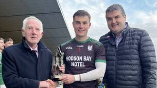 <p>St. Brigid's goalkeeper, Conor Carroll, receives his Player of the Match award from John Corcoran, sponsor, and Brian Carroll, Roscommon GAA Chairperson. Picture: Roscommon GAA</p>