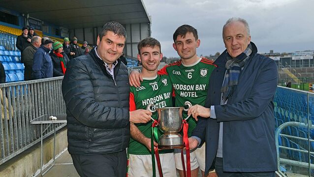 <p>Joint St. Brigid's captains, Paul McGrath and Brian Stack, receive the Fahey Cup from Roscommon GAA Chairperson, Brian Carroll, and Tim Hayes, Managing Director, Hodson Bay Hotel.</p>