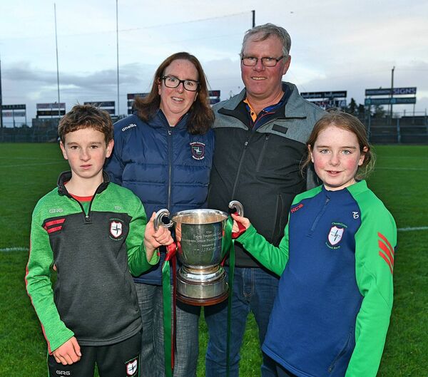 Tommy, Thomas, Anna and Claire Dolan with the Fahey Cup following St. Brigid's four-point victory against Pádraig Pearses in Saturday's county senior football final replay at King and Moffatt Dr. Hyde Park. Pictures: Gerard O'Loughlin