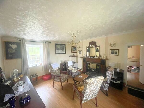 The house's interior includes four bedrooms, a central living room, kithcen, and formal dining room. The house's interior includes four bedrooms, a central living room, kithcen, and formal dining room.