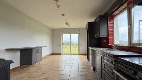 The kitchen is fully fitted and tiled.