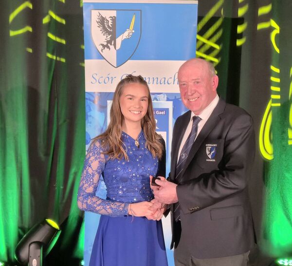 Gemma Casey, St. Dominic’s, is presented with her Connacht Scór na nÓg title for Solo Singing by Connacht Scór Committee Chairperson, Tommy Kelly, following last Saturday’s finals in Loughrea.