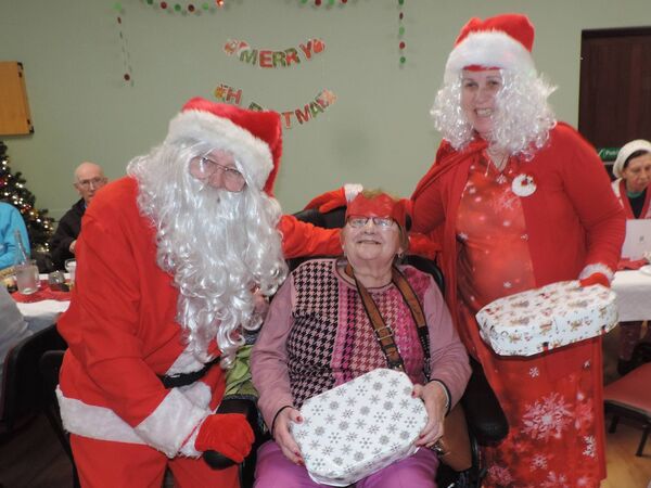 Santa and Mrs Claus congratulate Mary Waldron who celebrated her birthday at the Kilmovee Active Age Christmas party in Kilmovee Community Centre. Pic: James Hunt Photography 