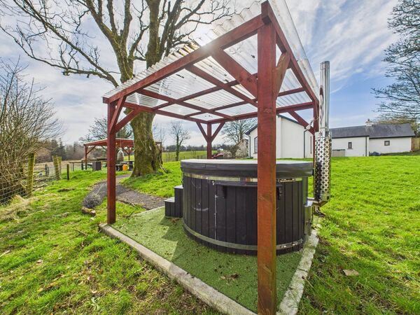A wood-burning hot tub offers a touch of indulgence.