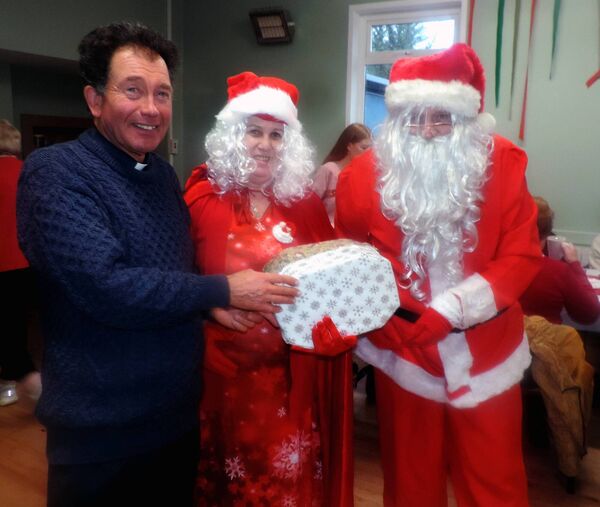 Fr Joseph Gavigan, PP Kilmovee, welcomes Santa and Mrs Claus to the Active Age Christmas party in Kilmovee. Pic: James Hunt Photography 