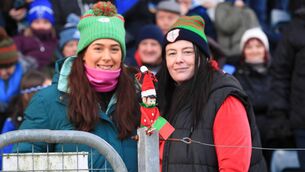 <p>TIME TO GET OFF THE FENCE: Nicole Nestor and Marie Kelly, with their "Elf on the Fence" during St. Brigid's victory against Scotstown, will be hoping that their team can land the ultimate prize in Croke Park on Sunday. But will the Elf be making the journey to GAA headquarters? Picture: Bernie O'Farrell </p>