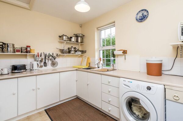 The kitchen is well laid out with a pantry and utility room located just off it. The kitchen is well laid out with a pantry and utility room located just off it.