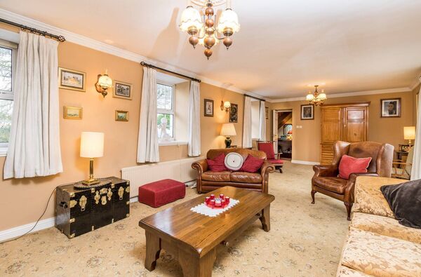 The property has a large and inviting sitting room featuring an open fire. The property has a large and inviting sitting room featuring an open fire.