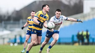<p>Diarmuid Murtagh looks to lay off a pass, despite the best efforts of Killian Lavelle, during last year's league meeting between Roscommon and Monaghan at King and Moffatt Dr. Hyde Park. Picture: INPHO/Tom Maher</p>