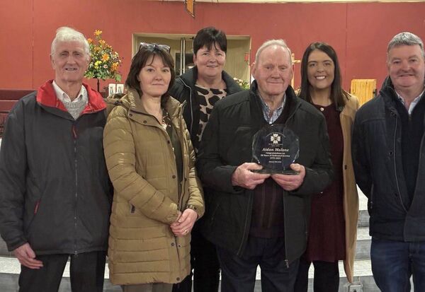 Aidan Malone holding his special presentation to mark his fifty years of service on Drumboylan National School's board of management.