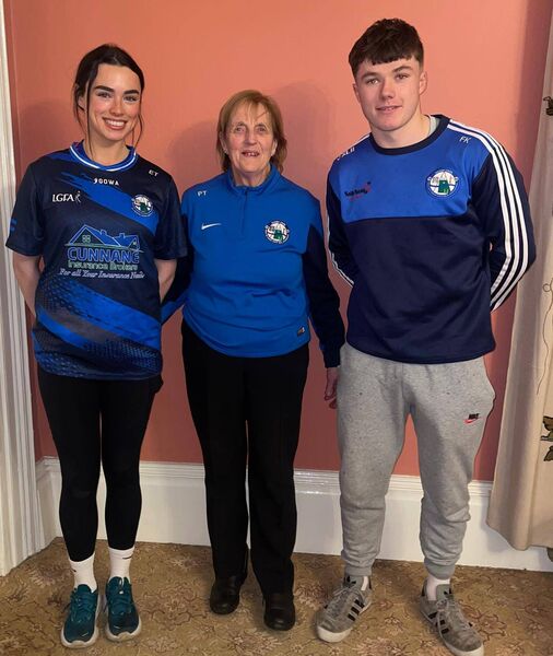 St Croan's GAA president Patricia Towey congratulates club members, Ella Thompson and Freddie Kelly on winning All-Ireland medals last season. Ella won hers with her college, MIC, Limerick and Freddie with his school, CBS, Roscommon. 