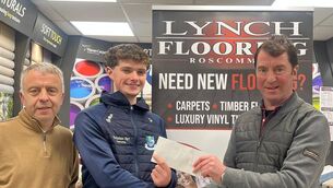 <p>Gabriel Lynch presenting a cheque for €1,200 to Niall Brennan, winner of the first prize in the Tremane Hurling Club Christmas Draw, sponsored by Lynch Flooring. Picture also includes David Carr, treasurer Tremane Hurling Club. </p>