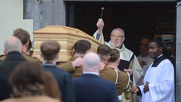 Bishop Kevin Doran blesses the coffin prior to the Funeral Mass for Captain Gilbert Muldowney. Pic: Gerard O'Loughlin