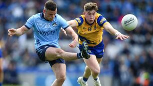 <p>Ross McGarry scores a point for Dublin, despite the best efforts of Roscommon's Daire Cregg, during the championship meeting between the teams in 2024. Picture: INPHO/Ken Sutton </p>