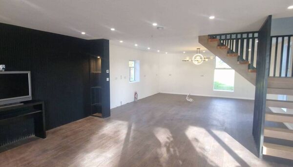 A standout feature of the home is the contemporary open-tread staircase with solid timber steps and bespoke balustrade, forming a central architectural statement. 