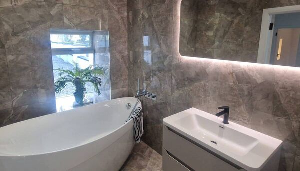 Bathrooms are finished to a high standard, including a freestanding bath, walk-in pumped showers and quality tiling. 