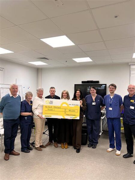 Pat Winston, Anne McLoone, matron for critical care follow up, Carmelita Winston, Ciaran Horohoe, Marian Ryan, Sheila Jordan, Emma Madine, matron for critical care outreach; Wilfred Petherbridge and Mick Dowling, head of nursing for critical care at the presentation of a cheque.