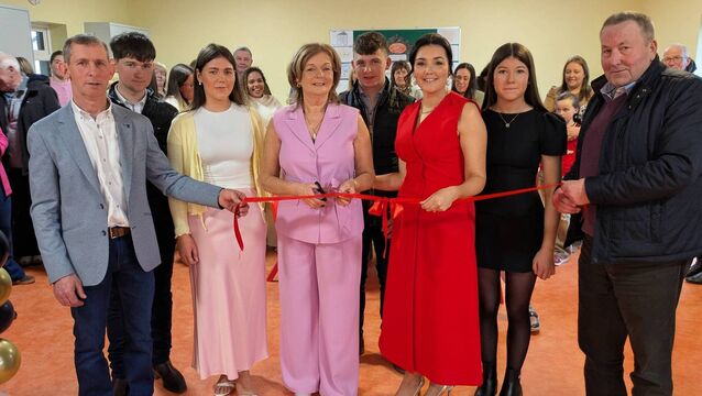 <p>Bernie Flynn cuts the tape at the official opening of the new Happy Feet Childcare facility at Tarmon, Castlerea. Pic: Liam Reynolds</p>