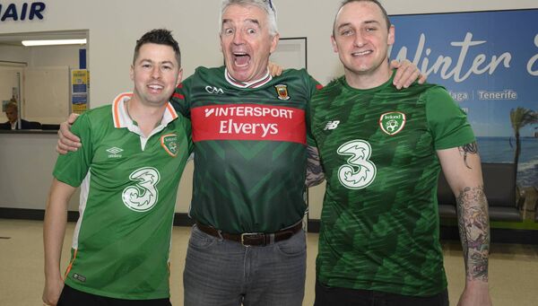 Ryanair chief executive Michael O’Leary paid a brief visit to Ireland West Airport Knock to mark the airport’s 40th anniversary. Danny Browne and Daniel Smyth, from Ballaghaderreen, who were travelling to Prague for the Ireland match are pictured here with him Pic: Michael McLaughlin