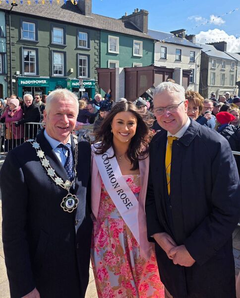 Cllr Liam Callaghan, Cathaoirleach of Roscommon County Council and chief Executive Shane Tiernan with the 2026 Rose of Roscommon Rebecca Collins at the Roscommon Town Easter Parade. 