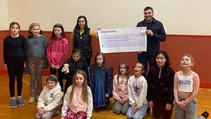 <p>Mary Lynskey, principal of Tibohine NS, presents a cheque for €1,600 from the recent Tractors and Tea fundraiser to the chairperson of Tibohine Community Centre Liam Mahon. Also pictured are pupils of the drama class in Tibohine Community Centre. Pic: Breda Durr </p>