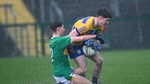 <p>Roscommon forward John McGuinness tries to maintain pressure, under pressure from Leitrim defender Luke Bramm-Farrell, in the tough conditions at King and Moffatt Dr. Hyde Park on Wednesday evening. Picture: Bernie O'Farrell</p>