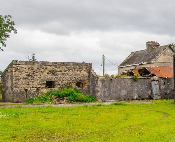 The property on 0.5 acres is complemented by associated farm buildings and a yard to the rear. 