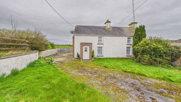 The dwelling is a traditional slated storey and a half style residence. 