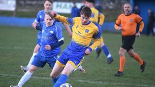 <p>Carrick Town's Fursey Butler (left) tries to halt the progress of Cloonfad United's Matthew Freyne. Picture: Gerard O'Loughlin.</p>