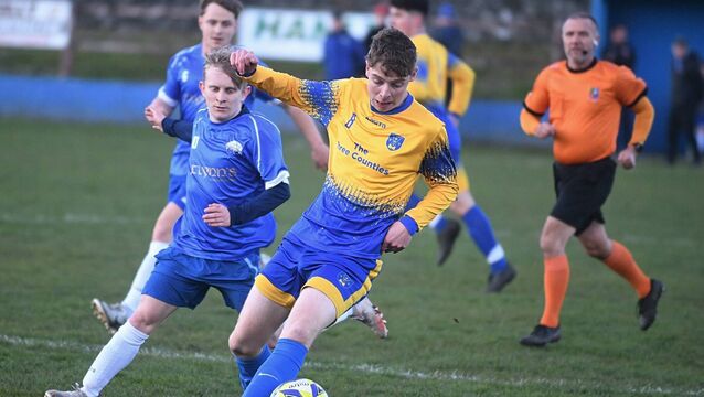 <p>Carrick Town's Fursey Butler (left) tries to halt the progress of Cloonfad United's Matthew Freyne. Picture: Gerard O'Loughlin.</p>