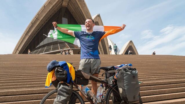 <p>Arigna man Fergal Guihen celebrates on the steps of Sydney Opera House after finishing his incredible 30,000km fundraising cycle from Roscommon to Australia. Pic: Owen Good</p>