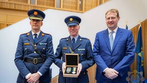 <p>Garda Commissioner Justin Kelly, Inspector Declan Egan and Justice Minister Jim O’Callaghan. Inspector Declan Egan is pictured with a Scott medal, posthumously awarded to his father, Detective Sergeant Michael Egan.</p>