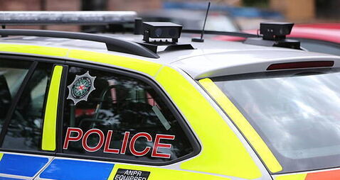 Man held on suspicion of attempted murder after police car driven at officer