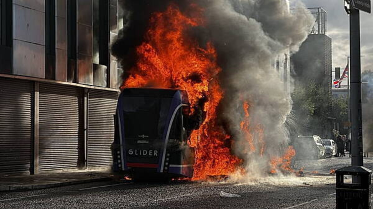 Bus set alight by masked protesters as violence flares following stabbing attack