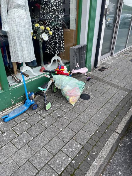 Clothes and items dumped outside a local charity shop.