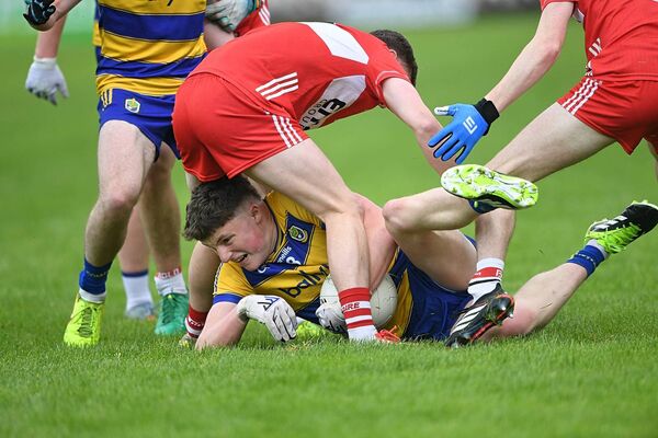 NOWHERE TO GO: Roscommon midfielder, Jack Lally, is grounded by Derry players during Saturday evening's All-Ireland Minor Football Championship quarter-final at Kingspan Breffni. Pictures: Gerard O'Loughlin